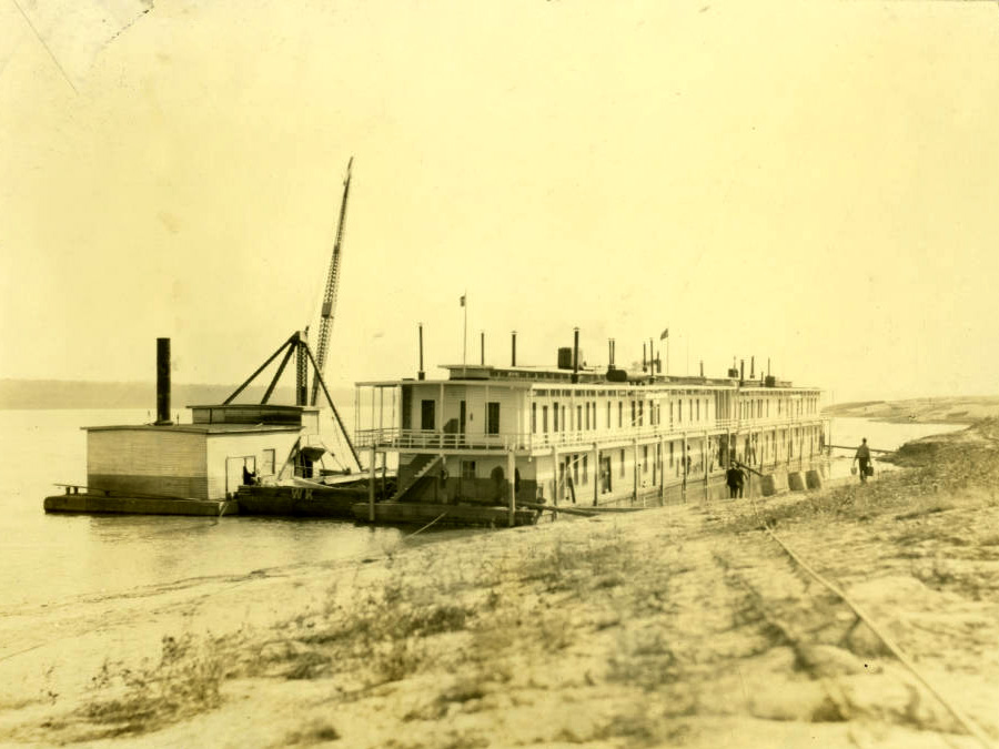 angled view of large boxy boat at shore with many doors angled view of large boxy boat at shore with many doors